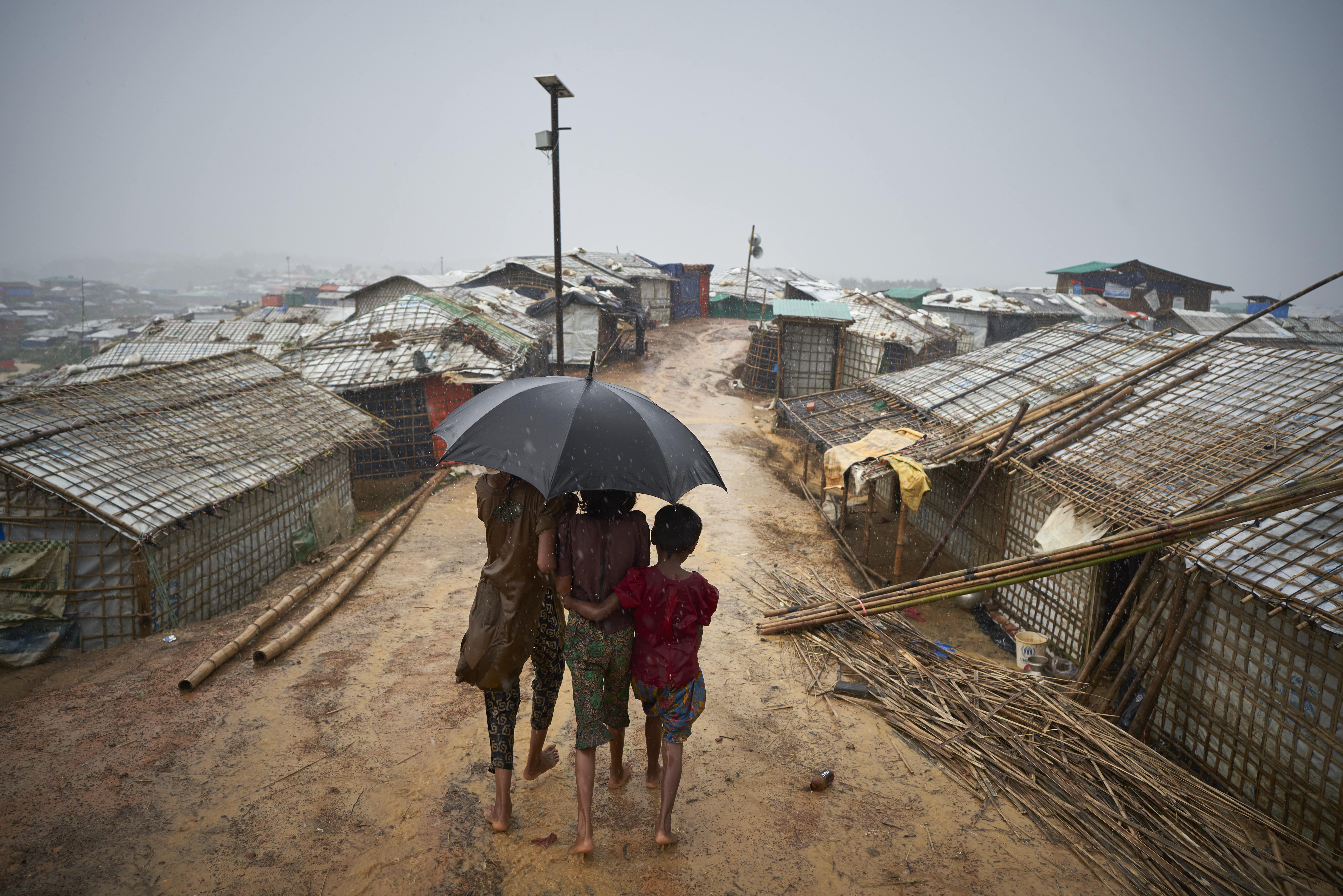 Bangladesh. Rohingya Refugees Walk Through A Heavy Downpour Min