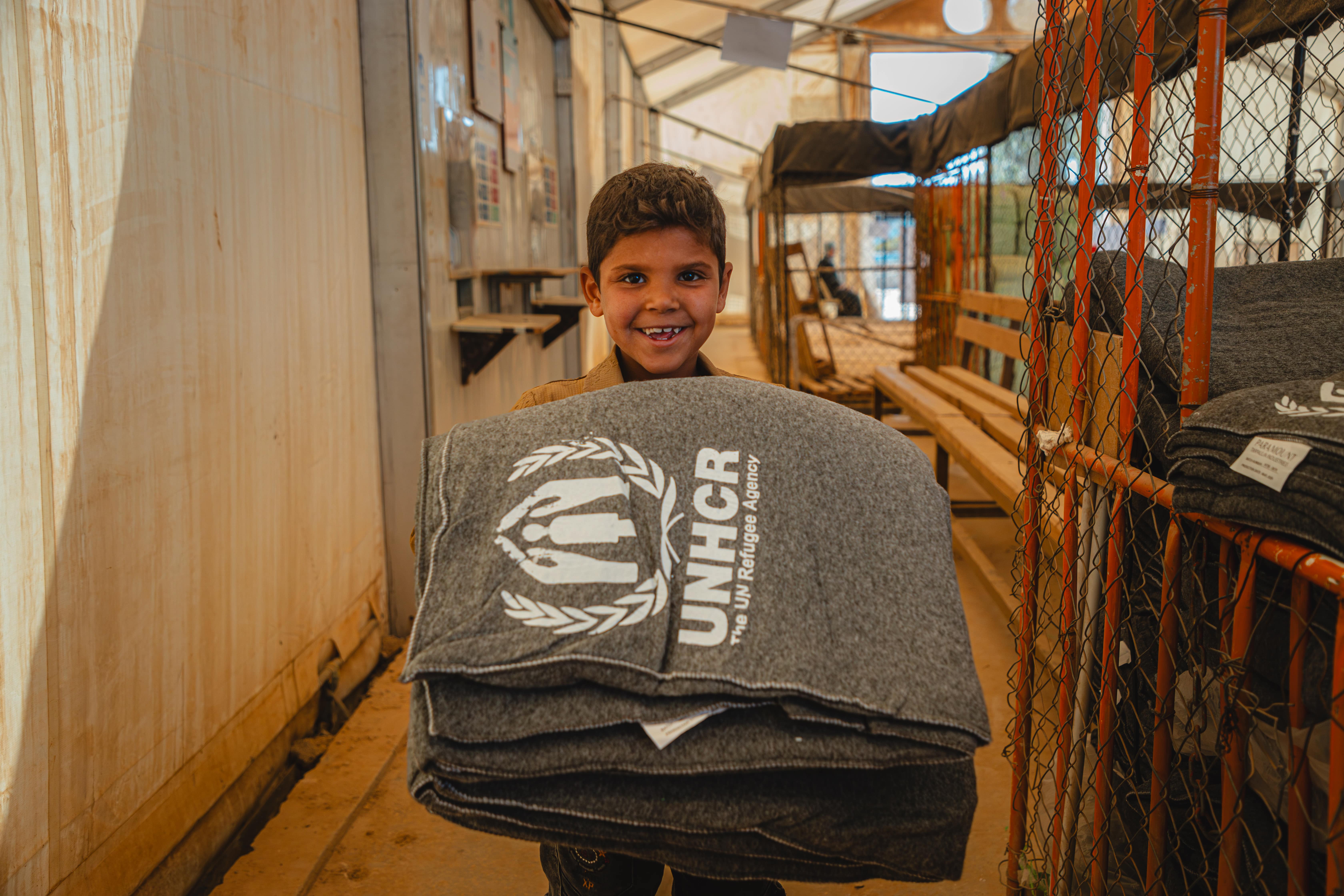 Jordan_Refugee boy collects winter blankets in Za'atari camp