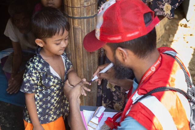 Small Bangladesh. Marking A Child's Finger After Having Administered A Dose Of Cholera Medicine