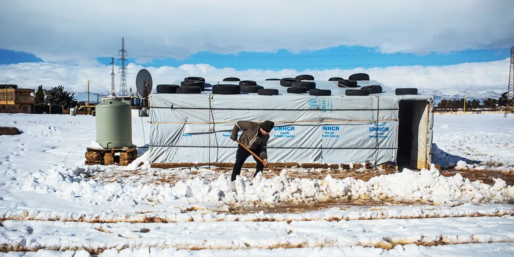 Ahmed, a Syrian refugee from Raqqa, removes snow with a shovel outside his home in the informal settlement camp of Doures, Lebanon. @UNHCR/ Shabia Mantoo